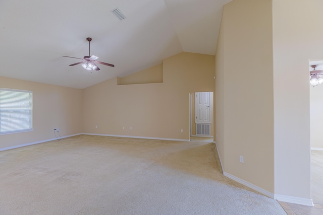 carpeted empty room featuring lofted ceiling and ceiling fan