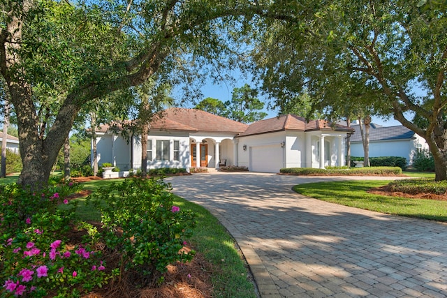 mediterranean / spanish-style home with a garage