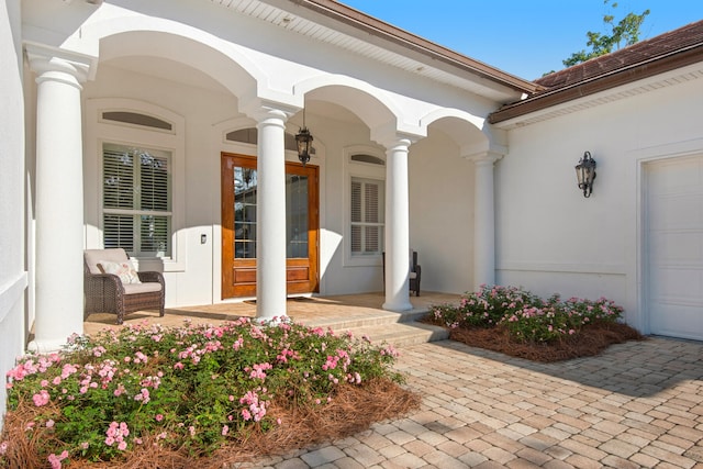 view of exterior entry with a garage