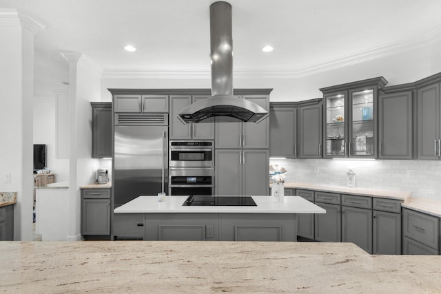 kitchen featuring appliances with stainless steel finishes, crown molding, island range hood, and gray cabinets