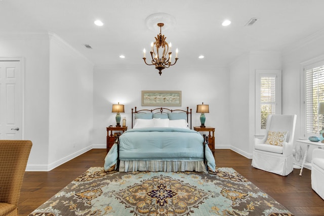 bedroom featuring dark hardwood / wood-style floors, ornamental molding, and a chandelier