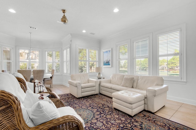 living room with crown molding, light tile patterned floors, and a wealth of natural light