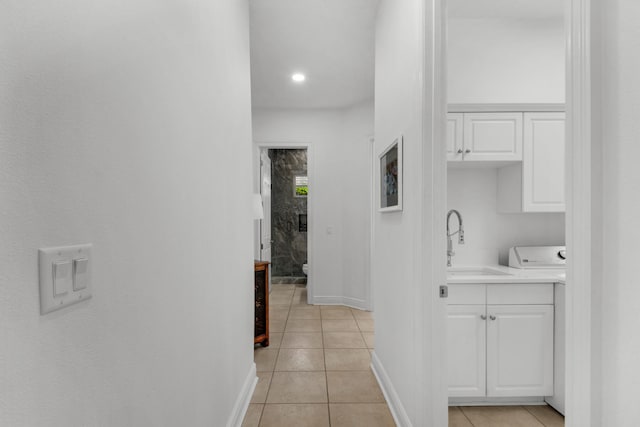 hall with light tile patterned flooring and sink