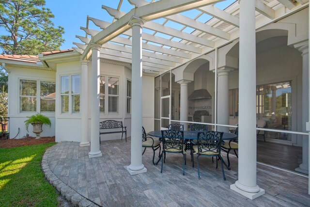 view of patio / terrace featuring area for grilling and a pergola