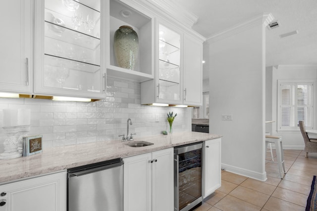 kitchen featuring wine cooler, sink, white cabinetry, light tile patterned floors, and light stone countertops