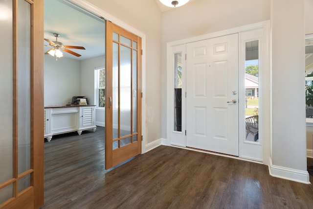 foyer featuring dark wood-type flooring, ceiling fan, and french doors