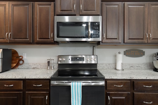 kitchen with appliances with stainless steel finishes and dark brown cabinetry