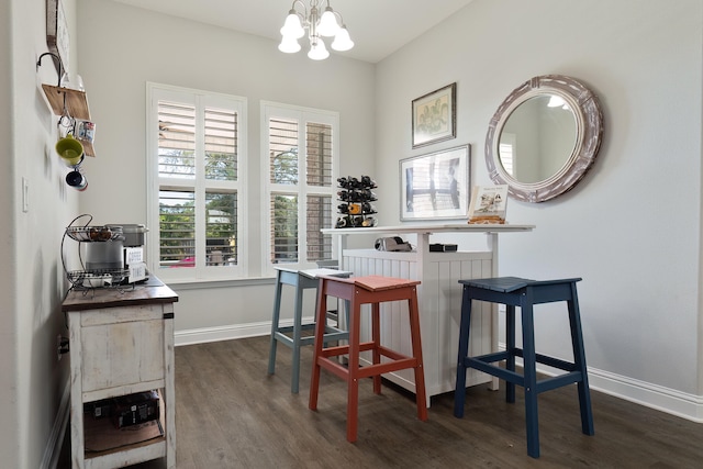 dining room featuring a notable chandelier and dark hardwood / wood-style flooring