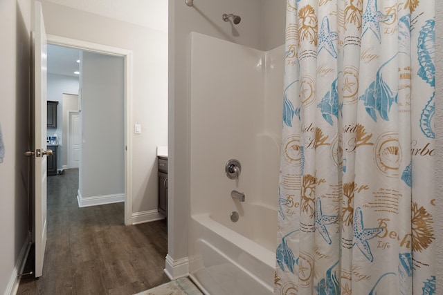 bathroom featuring vanity, hardwood / wood-style flooring, and shower / bathtub combination with curtain