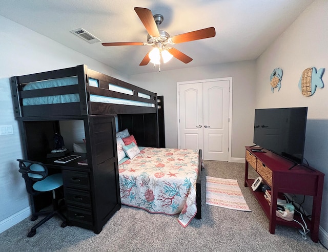 carpeted bedroom with a closet and ceiling fan