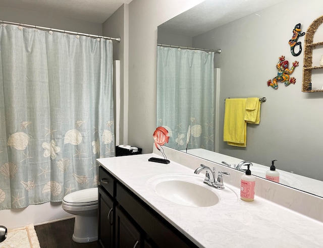 bathroom with vanity, hardwood / wood-style floors, and toilet