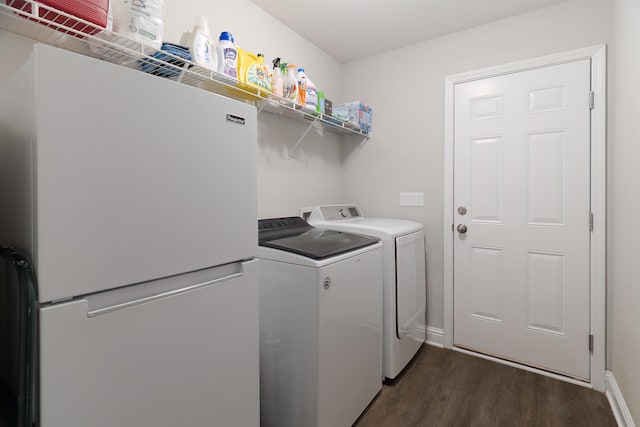 laundry room with independent washer and dryer and dark hardwood / wood-style floors