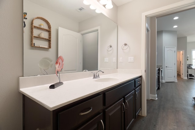 bathroom with vanity and hardwood / wood-style flooring