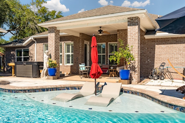 view of swimming pool featuring a patio, a hot tub, and ceiling fan