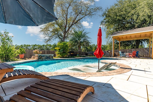 view of swimming pool featuring a gazebo, a hot tub, pool water feature, and a patio area