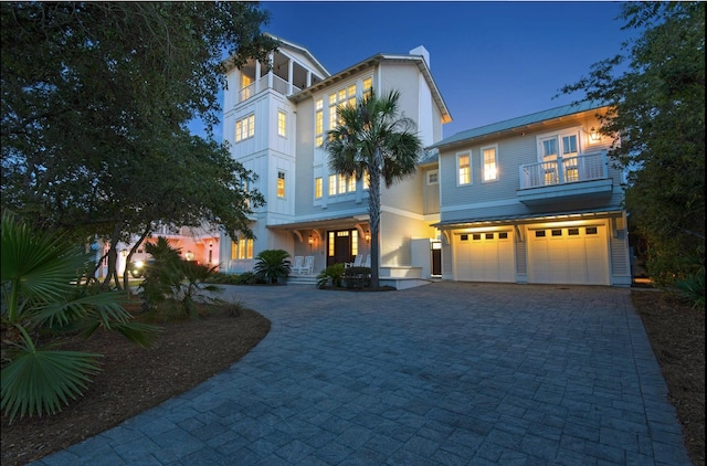 view of front of home with a balcony and a garage