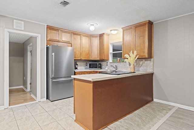 kitchen with wood walls, kitchen peninsula, decorative backsplash, appliances with stainless steel finishes, and ornamental molding