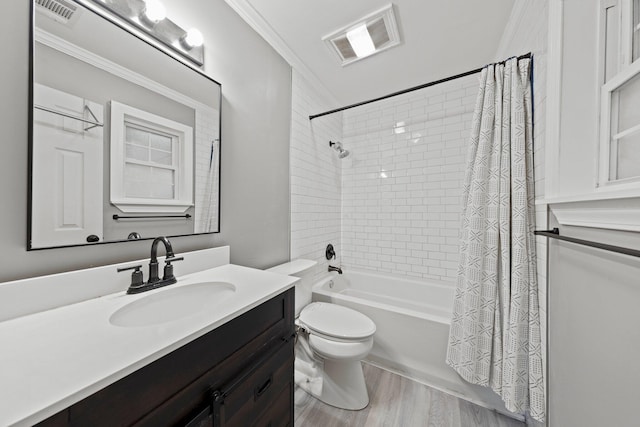 full bathroom featuring vanity, ornamental molding, wood-type flooring, shower / bath combo with shower curtain, and toilet