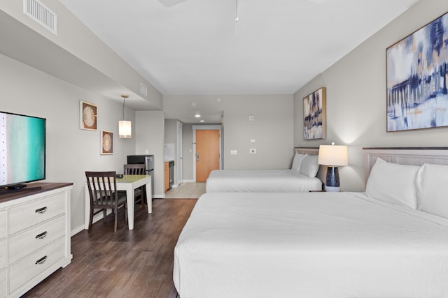 bedroom with dark hardwood / wood-style flooring