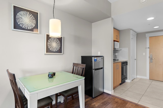 dining area with light wood-type flooring