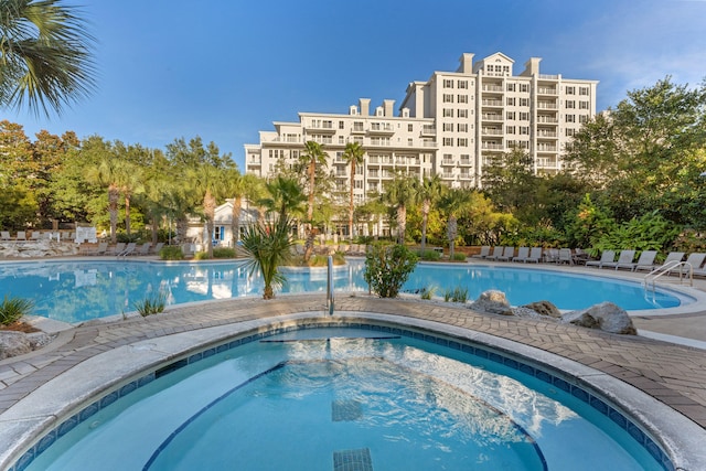 view of pool with a hot tub