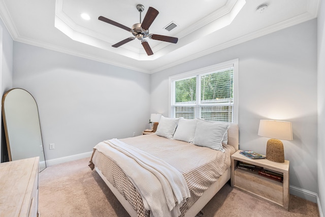 bedroom with ornamental molding, a tray ceiling, and ceiling fan