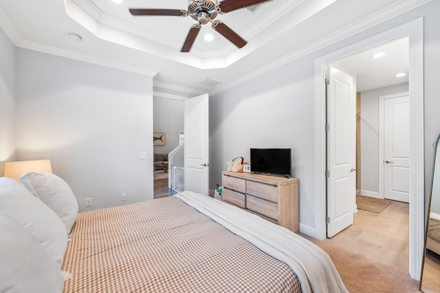 carpeted bedroom with ceiling fan, a raised ceiling, and crown molding