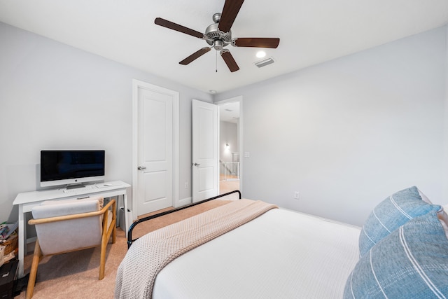 bedroom with ceiling fan and light carpet