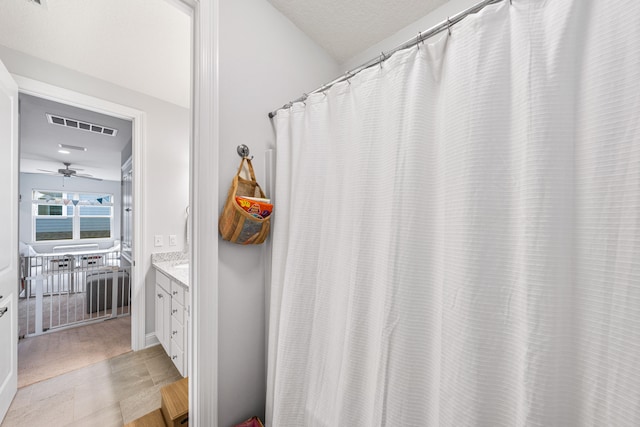 bathroom with ceiling fan, vanity, and tile patterned floors