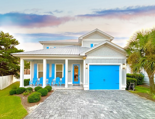 view of front facade featuring a garage and covered porch