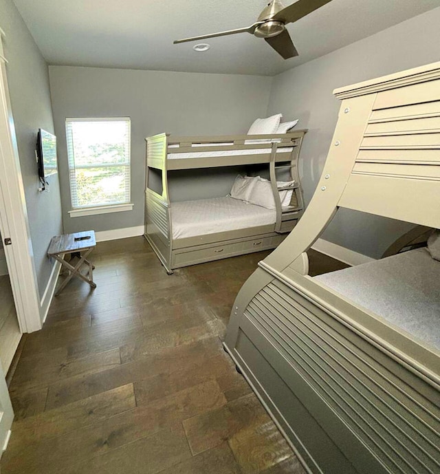 unfurnished bedroom featuring ceiling fan and dark hardwood / wood-style flooring