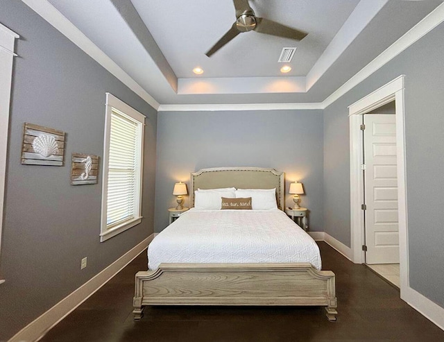 bedroom featuring ceiling fan and a raised ceiling