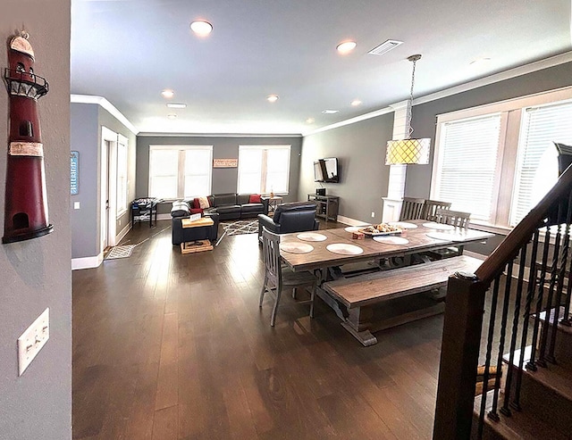 dining area featuring ornamental molding and dark wood-type flooring