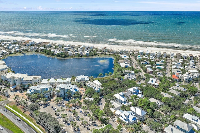 drone / aerial view with a beach view and a water view