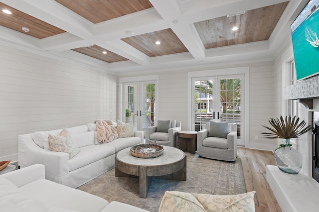 living room with french doors, wooden walls, coffered ceiling, wooden ceiling, and light hardwood / wood-style floors