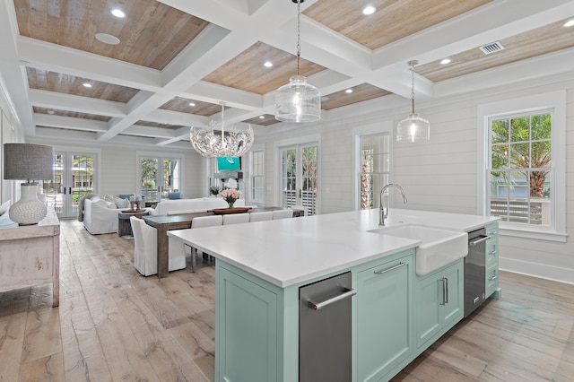 kitchen featuring pendant lighting, light hardwood / wood-style floors, a kitchen island with sink, and sink