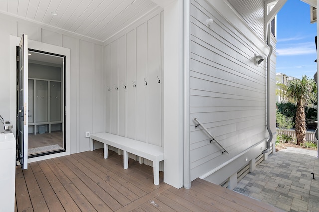 mudroom featuring wooden walls and light hardwood / wood-style floors