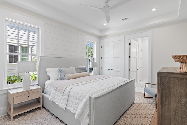 bedroom with multiple windows and ceiling fan