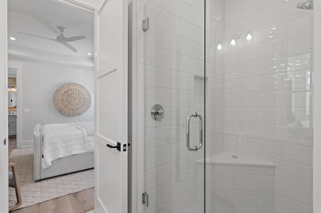 bathroom with walk in shower, hardwood / wood-style floors, and ceiling fan