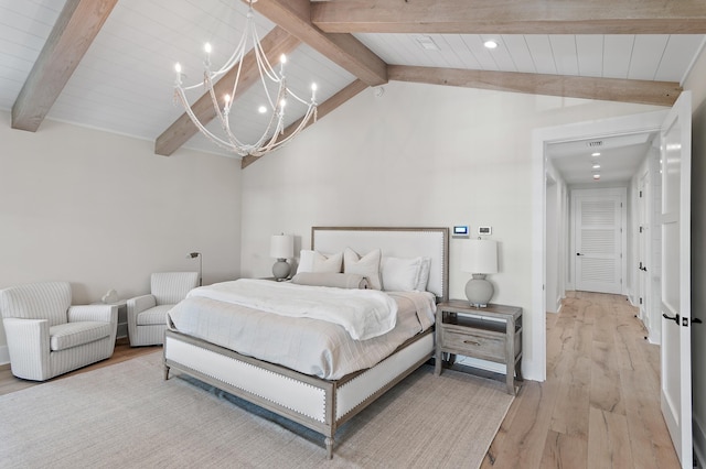 bedroom with vaulted ceiling with beams, light wood-type flooring, and a chandelier