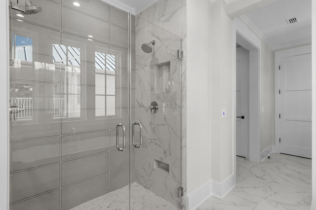 bathroom featuring ornamental molding and a shower with door