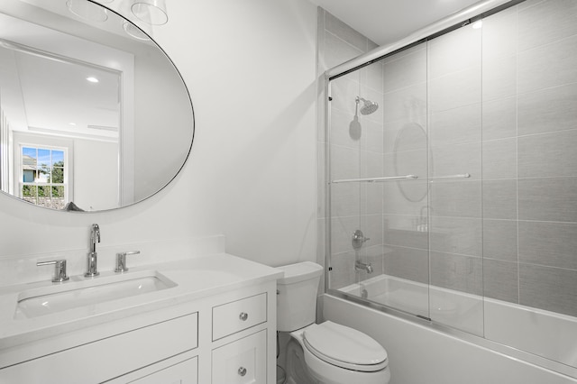 full bathroom featuring enclosed tub / shower combo, vanity, and toilet