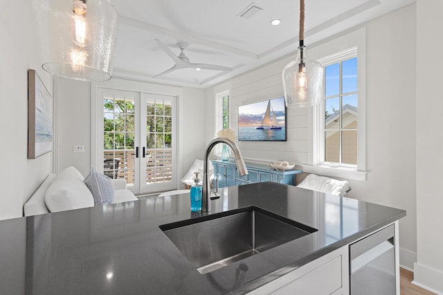 kitchen with ceiling fan, hanging light fixtures, sink, french doors, and hardwood / wood-style floors