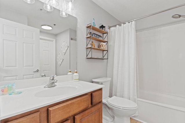 full bathroom with vanity, shower / tub combo, and toilet