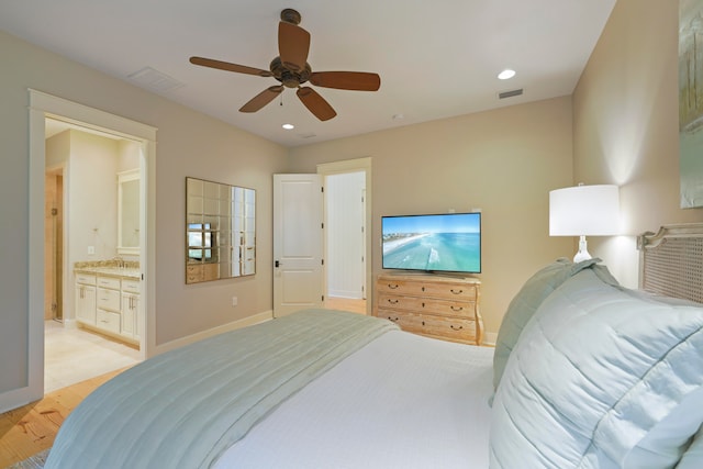 bedroom featuring light hardwood / wood-style flooring, connected bathroom, ceiling fan, and sink