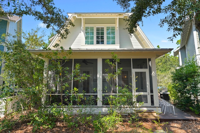 exterior space with ceiling fan and a sunroom