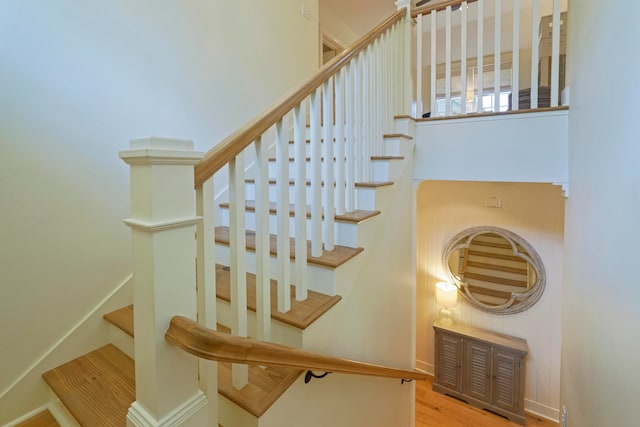 stairs featuring hardwood / wood-style floors