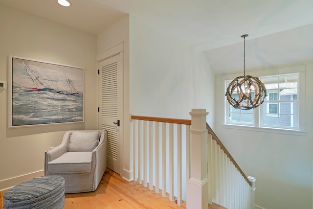 sitting room with light hardwood / wood-style flooring and a chandelier