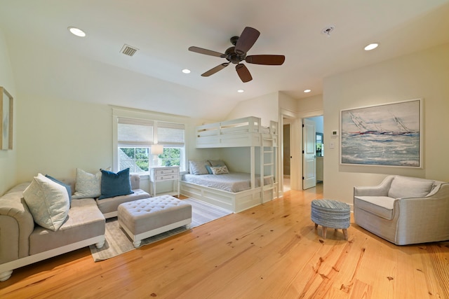 bedroom with lofted ceiling, ceiling fan, and light hardwood / wood-style flooring