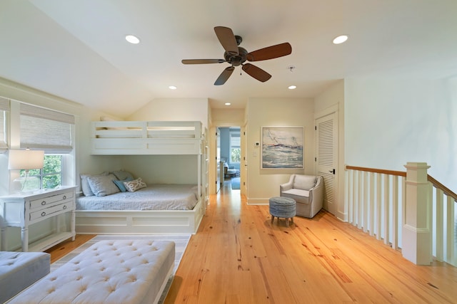 bedroom featuring ceiling fan, vaulted ceiling, a closet, and light hardwood / wood-style floors